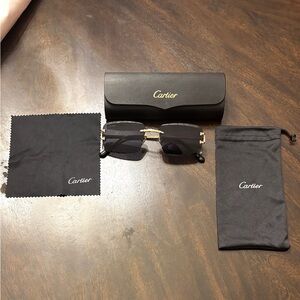 Cartier glasses, semi rimless design with gold toned frame and dark lenses!